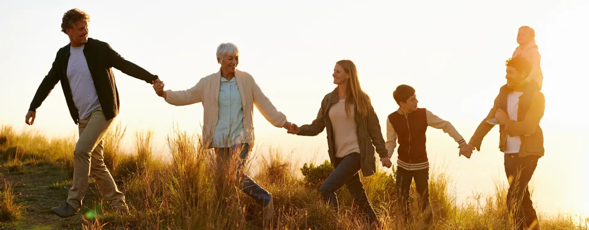 Shot of a happy family holding hands on a morning walk together